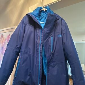 The North Face Blue Performance Jacket with High Collar and Zipper
